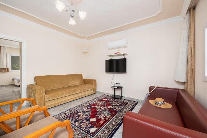 Open-plan living room with sofas, dining area, kitchen, A/C, WiFi internet, and satellite TV . - Villa Bliss . (Photo Gallery) }}