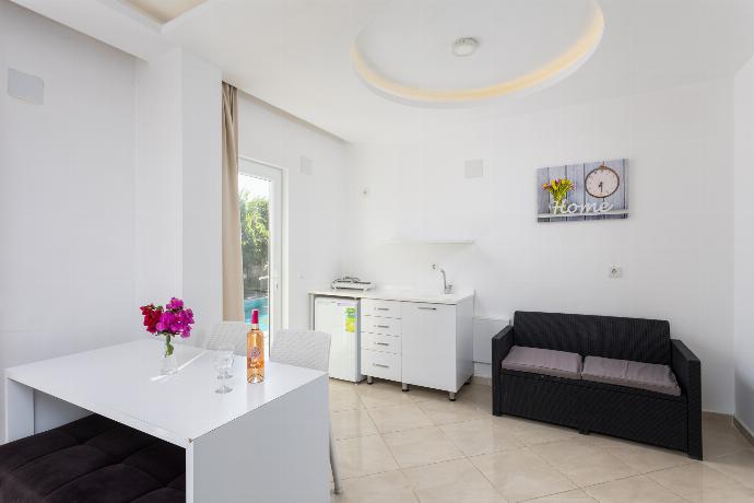 Double bedroom with A/C, kitchenette, sofa, and TV . - Villa Casa Mia . (Photo Gallery) }}