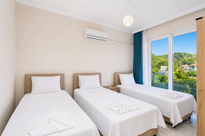 Bedroom with 3 single beds and A/C . - Villa Azalea 2 . (Photo Gallery) }}