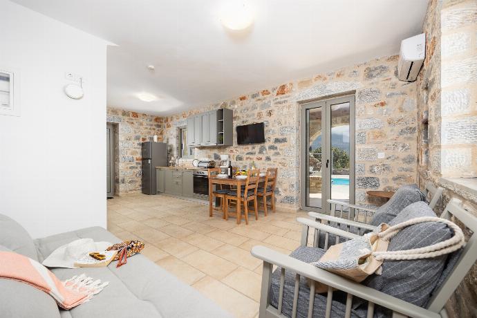 Open-plan living room with sofa, dining area, kitchen, A/C, WiFi internet, and satellite TV . - Villa Dioni Ena . (Photo Gallery) }}