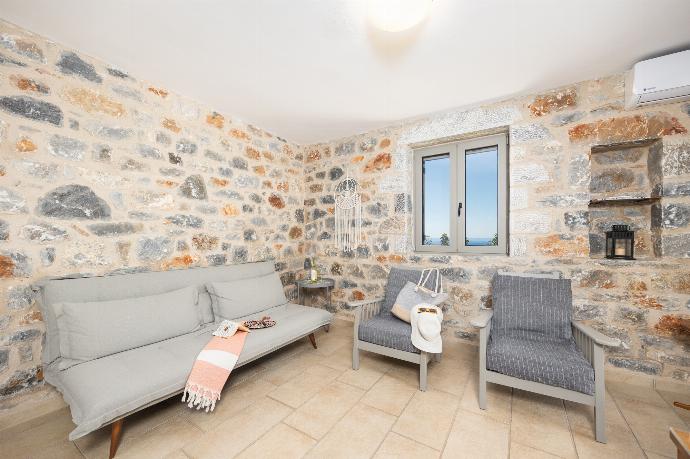 Open-plan living room with sofa, dining area, kitchen, A/C, WiFi internet, and satellite TV . - Villa Dioni Tria . (Photo Gallery) }}