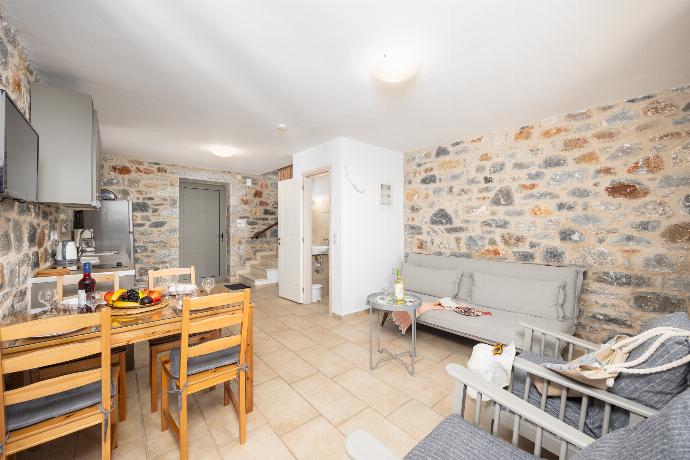 Open-plan living room with sofa, dining area, kitchen, A/C, WiFi internet, and satellite TV . - Villa Dioni Tria . (Photo Gallery) }}