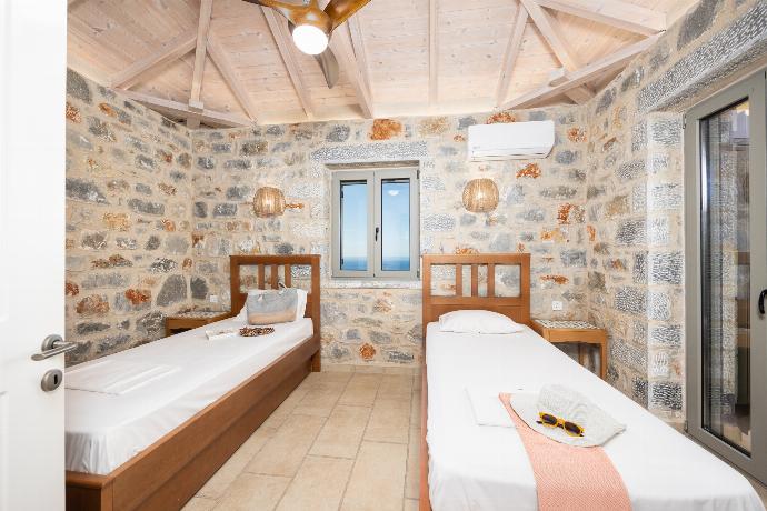 Twin bedroom with A/C . - Villa Dioni Tria . (Photo Gallery) }}