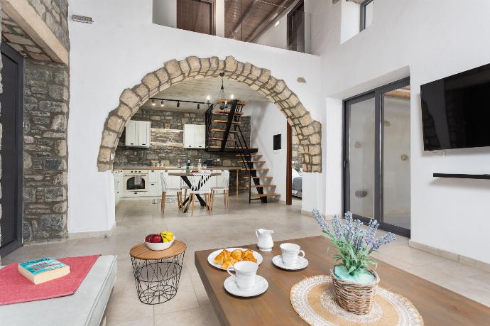 Open-plan living room with sofa, dining area, kitchen, A/C, WiFi internet, and satellite TV . - La Casa Di Pietre 2 . (Photo Gallery) }}