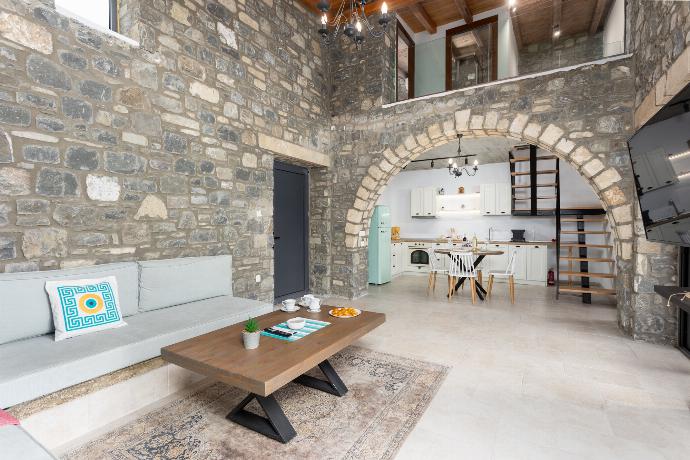 Open-plan living room with sofa, dining area, kitchen, A/C, WiFi internet, and satellite TV . - La Casa Di Pietre 3 . (Photo Gallery) }}