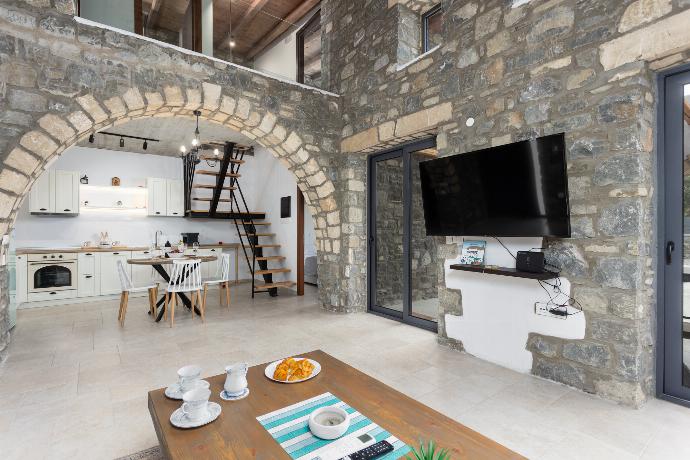 Open-plan living room with sofa, dining area, kitchen, A/C, WiFi internet, and satellite TV . - La Casa Di Pietre 3 . (Photo Gallery) }}