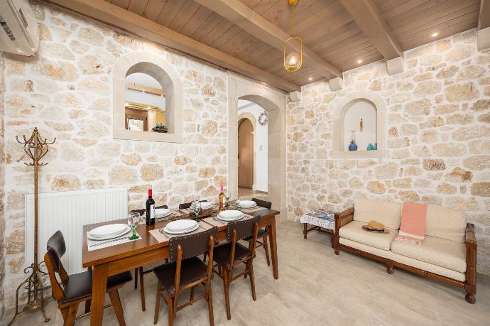 Living room with sofa, dining area, ornamental fireplace, A/C, WiFi internet, and satellite TV . - Villa Koupos . (Photo Gallery) }}