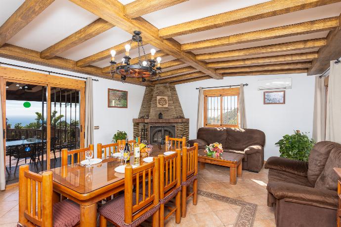 Open-plan living room with sofas, dining area, kitchen, ornamental fireplace, A/C, WiFi internet, and satellite TV . - Villa Bonifacio . (Photo Gallery) }}