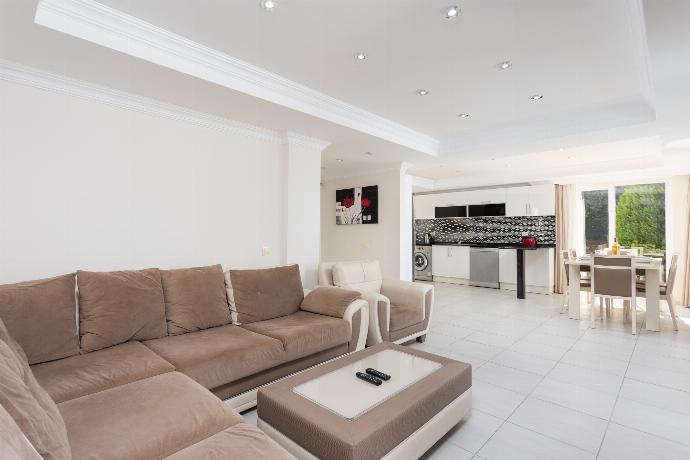 Open-plan living room with sofas, dining area, kitchen, ornamental fireplace, A/C, WiFi internet, and satellite TV . - Golden Heights 5 . (Photo Gallery) }}