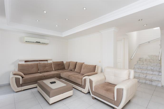 Open-plan living room with sofas, dining area, kitchen, ornamental fireplace, A/C, WiFi internet, and satellite TV . - Golden Heights 5 . (Photo Gallery) }}