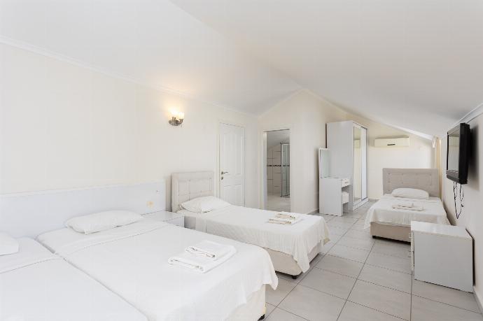 Bedroom with 4 single beds, en suite bathroom, and A/C . - Golden Heights 5 . (Photo Gallery) }}