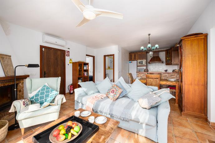 Open-plan living room with sofa, dining area, kitchen, ornamental fireplace, A/C, WiFi internet, and satellite TV . - Villa Los Espejos De Frigiliana . (Photo Gallery) }}