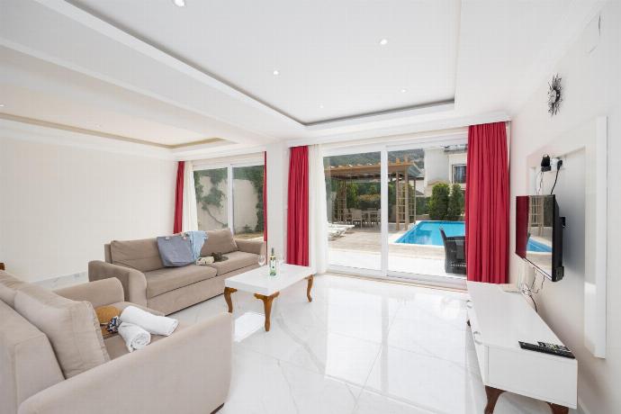 Living room with sofas, dining area, A/C, WiFi internet, and satellite TV . - Villa Premium F . (Photo Gallery) }}