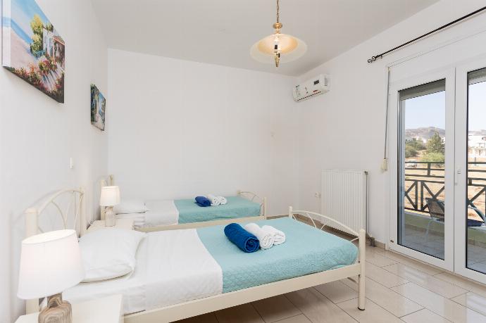 Twin bedroom with A/C and balcony access . - Amphitrite Villa . (Photo Gallery) }}