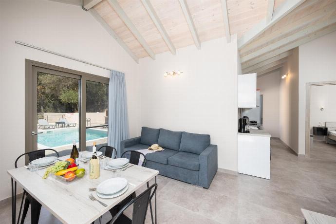 Open-plan living room with sofa, dining area, kitchen, A/C, WiFi internet, and satellite TV . - Villa Sia . (Photo Gallery) }}