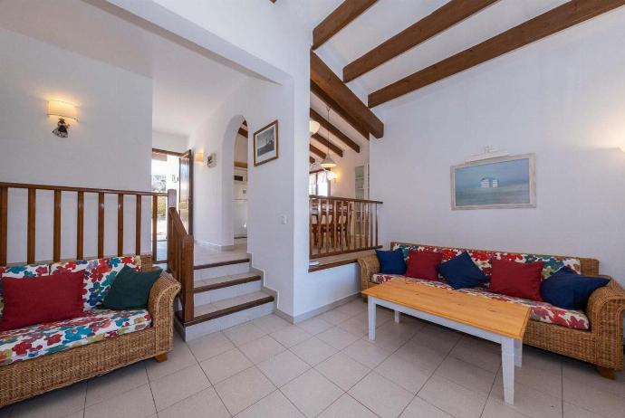 Open-plan living room with sofas, ornamental fireplace, dining area, kitchen, A/C, WiFi internet, satellite TV, DVD player, and pool terrace access . - Villa Binibels . (Photo Gallery) }}