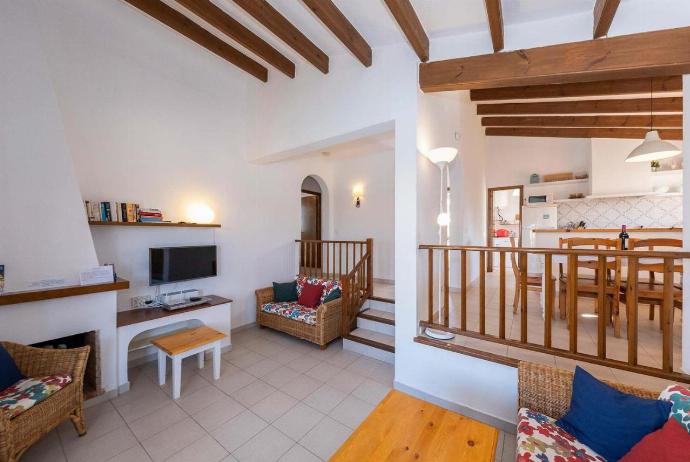 Open-plan living room with sofas, ornamental fireplace, dining area, kitchen, A/C, WiFi internet, satellite TV, DVD player, and pool terrace access . - Villa Binibels . (Photo Gallery) }}