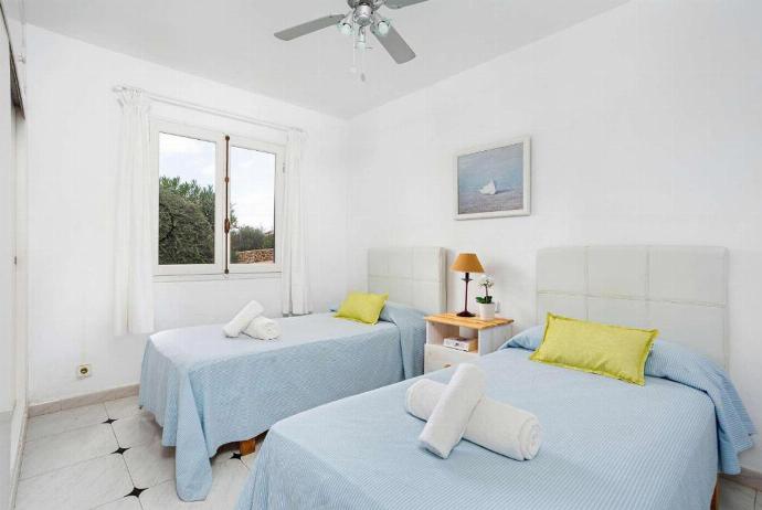 Twin bedroom with a fan . - Villa Binilisa . (Photo Gallery) }}