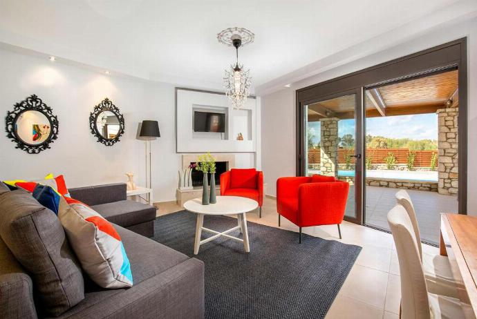 Open plan living room with comfortable sofas, A/C, WiFi, ornamental fireplace, patio doors, TV. . - Villa Ira . (Galleria fotografica) }}