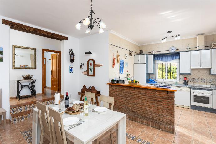 Open-plan living room with sofa, dining area, kitchen, ornamental fireplace, WiFi internet, and satellite TV . - Villa Medina Paloma . (Photo Gallery) }}
