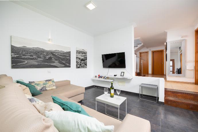 Open-plan living room with sofa, dining area, kitchen, ornamental fireplace, A/C, WiFi internet, and satellite TV . - Villa Ariel . (Photo Gallery) }}