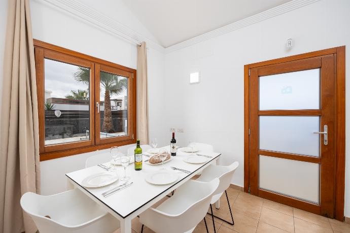 Open-plan living room with sofa, dining area, kitchen, ornamental fireplace, A/C, WiFi internet, and satellite TV . - Villa Ariel . (Photo Gallery) }}
