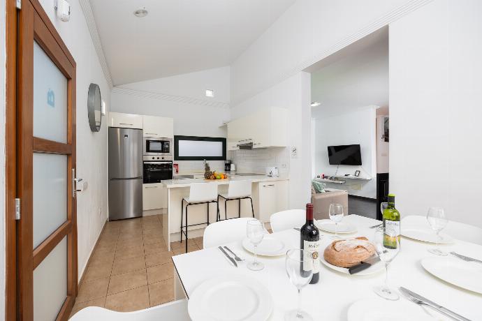 Open-plan living room with sofa, dining area, kitchen, ornamental fireplace, A/C, WiFi internet, and satellite TV . - Villa Ariel . (Photo Gallery) }}