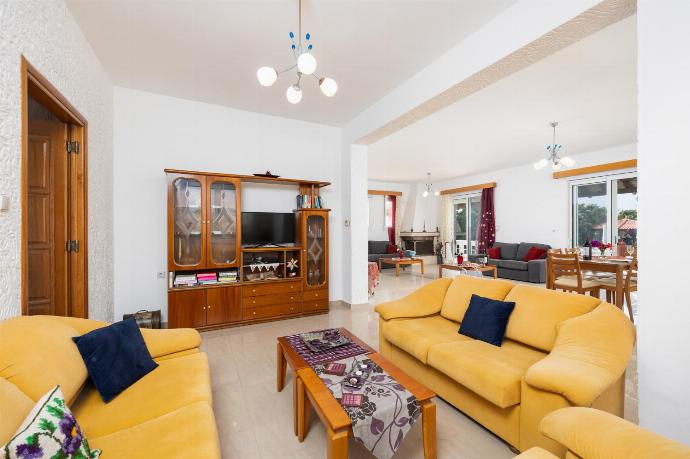Living room with sofas, dining area, ornamental fireplace, A/C, WiFi internet, and satellite TV . - Villa Sunset . (Photo Gallery) }}