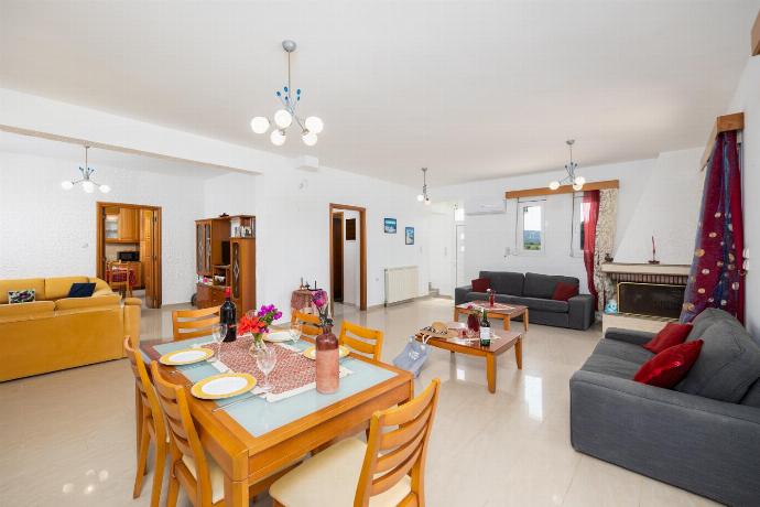 Living room with sofas, dining area, ornamental fireplace, A/C, WiFi internet, and satellite TV . - Villa Sunset . (Photo Gallery) }}