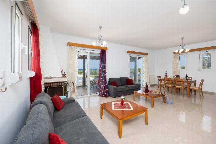 Living room with sofas, dining area, ornamental fireplace, A/C, WiFi internet, and satellite TV . - Villa Sunset . (Photo Gallery) }}