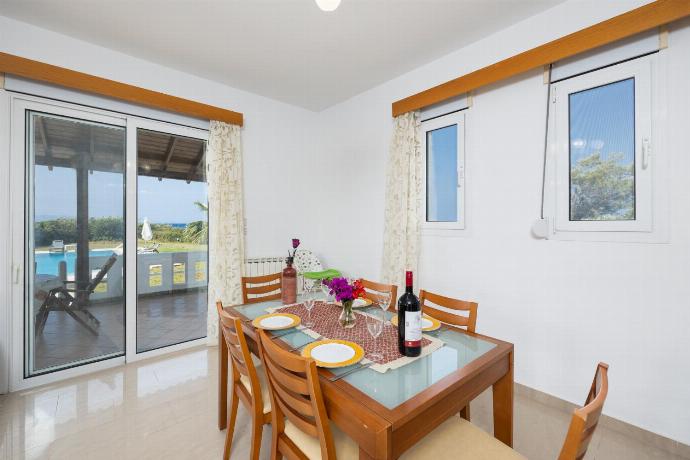 Living room with sofas, dining area, ornamental fireplace, A/C, WiFi internet, and satellite TV . - Villa Sunset . (Photo Gallery) }}