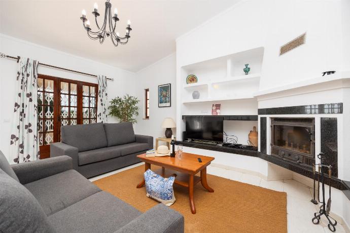 Living room with sofas, dining area, ornamental fireplace, A/C, WiFi internet, and satellite TV . - Villa Gemini . (Photo Gallery) }}