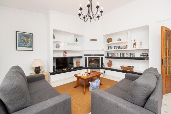 Living room with sofas, dining area, ornamental fireplace, A/C, WiFi internet, and satellite TV . - Villa Gemini . (Photo Gallery) }}