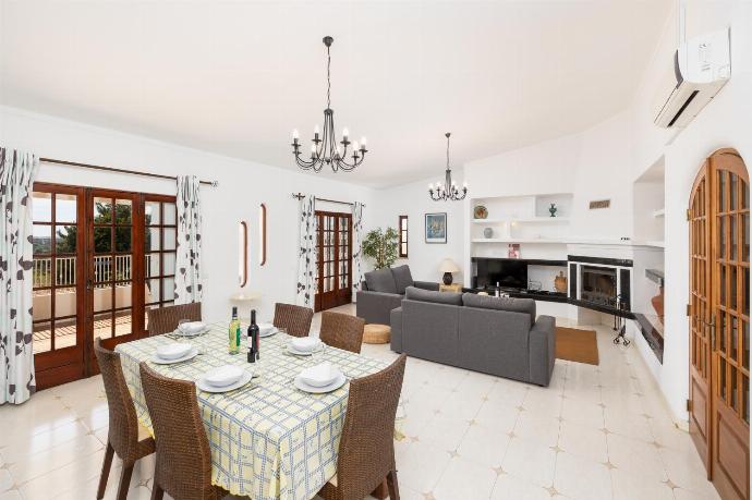 Living room with sofas, dining area, ornamental fireplace, A/C, WiFi internet, and satellite TV . - Villa Gemini . (Photo Gallery) }}