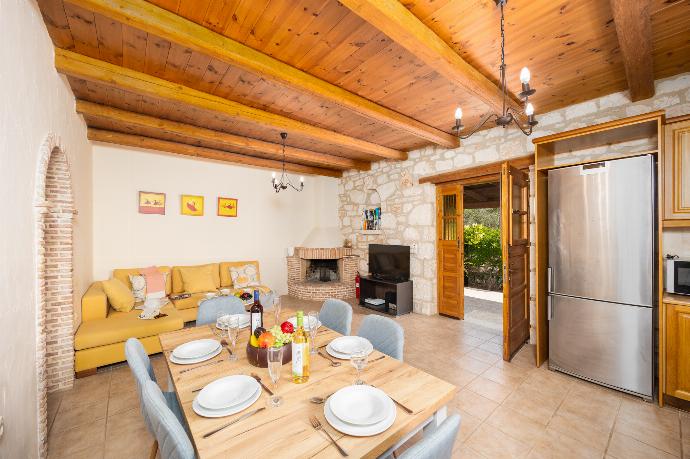 Open-plan living room with sofa, dining area, kitchen, ornamental fireplace, A/C, WiFi internet, and satellite TV . - Villa Aloni . (Photo Gallery) }}