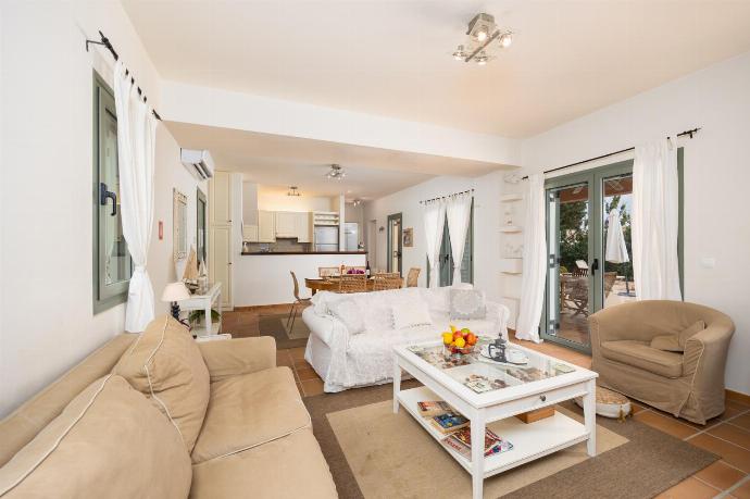 Open-plan living room with sofas, dining area, kitchen, A/C, WiFi internet, and satellite TV . - Villa Ionian Rose . (Photo Gallery) }}