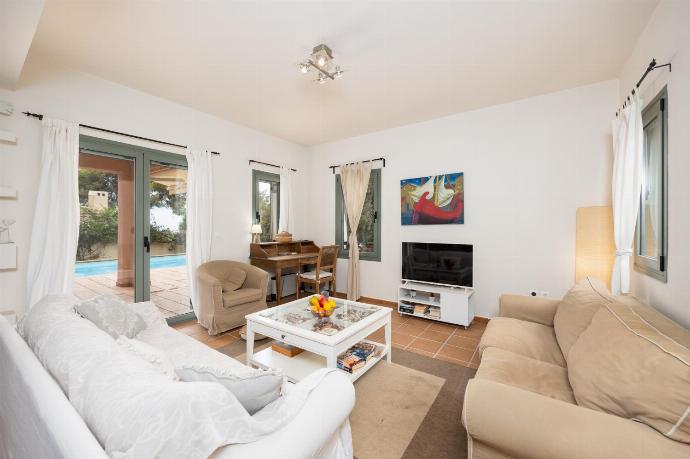 Open-plan living room with sofas, dining area, kitchen, A/C, WiFi internet, and satellite TV . - Villa Ionian Rose . (Photo Gallery) }}