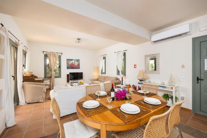 Open-plan living room with sofas, dining area, kitchen, A/C, WiFi internet, and satellite TV . - Villa Ionian Rose . (Photo Gallery) }}
