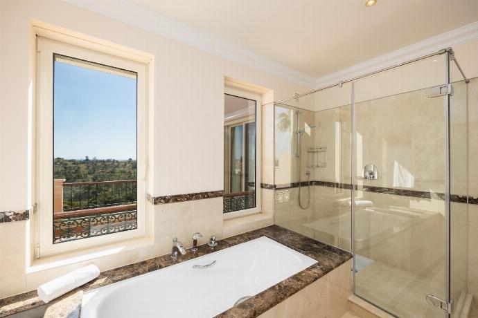 En suite bathroom with bath and shower . - Villa Monte Rei . (Photo Gallery) }}