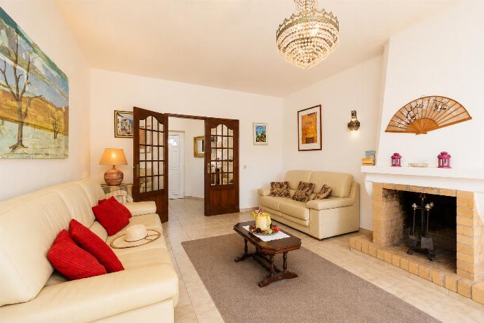 Living room with sofas, ornamental fireplace, A/C, WiFi internet, and satellite TV . - Casa Das Areias . (Photo Gallery) }}