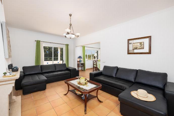 Living room with sofas, ornamental fireplace, A/C, WiFi internet, and satellite TV . - Villa Sol Nascente . (Photo Gallery) }}