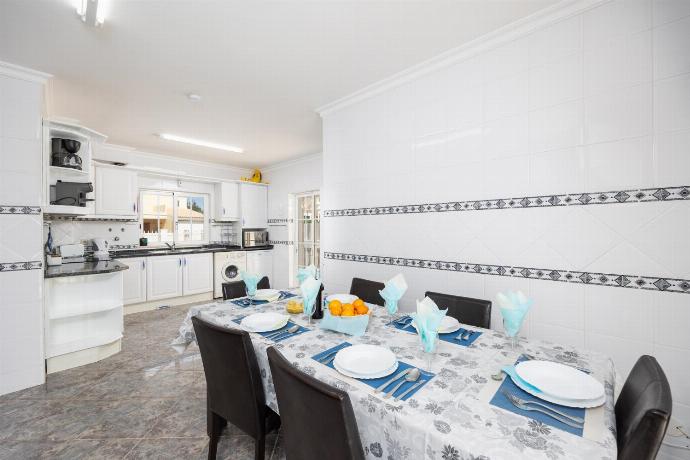 Dining area with sofa, ornamental fireplace, A/C, and TV . - Villa Marlene . (Photo Gallery) }}