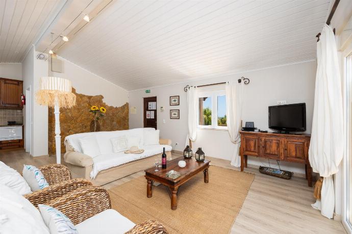 Open-plan living room with sofa, dining area, kitchen, A/C, WiFi internet, and satellite TV . - Villa Irene . (Photo Gallery) }}