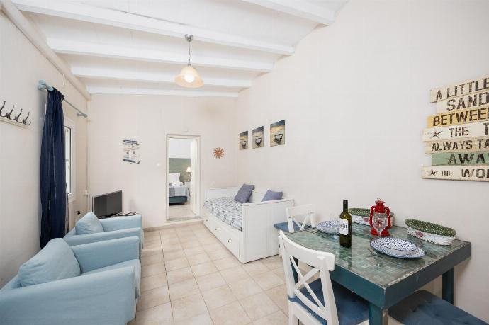 Open-plan living room with seating, dining area, kitchen, WiFi internet, and satellite TV . - Levrecchio Beach Cottage . (Photo Gallery) }}