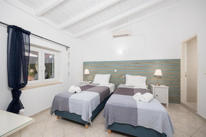 Twin bedroom with en suite bathroom and A/C . - Levrecchio Beach Cottage . (Photo Gallery) }}