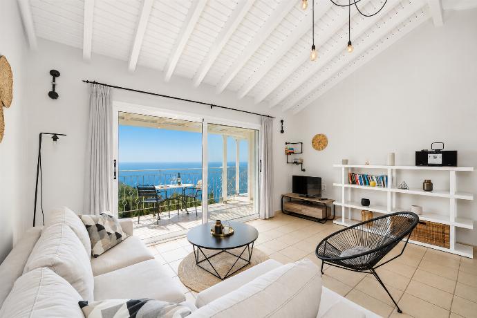 Open-plan living room with sofa, dining area, kitchen, A/C, WiFi internet, satellite TV, and sea views . - Villa Jasmine . (Photo Gallery) }}