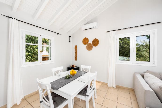 Open-plan living room with sofa, dining area, kitchen, A/C, WiFi internet, satellite TV, and sea views . - Villa Jasmine . (Photo Gallery) }}