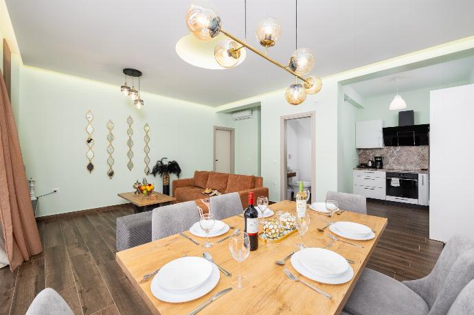 Open-plan living room with sofa, dining area, kitchen, A/C, WiFi internet, satellite TV, and sea views . - Villa Alora . (Photo Gallery) }}