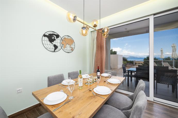 Open-plan living room with sofa, dining area, kitchen, A/C, WiFi internet, satellite TV, and sea views . - Villa Alora . (Photo Gallery) }}