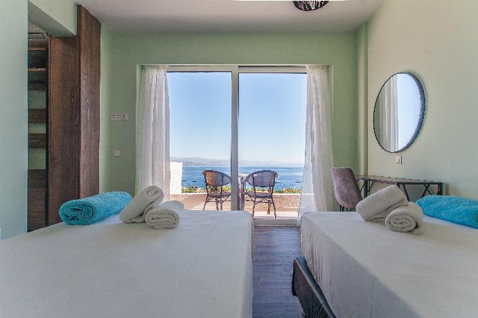 Twin bedroom with en suite bathroom, A/C, and balcony access with panoramic sea views . - Villa Daisy . (Photo Gallery) }}